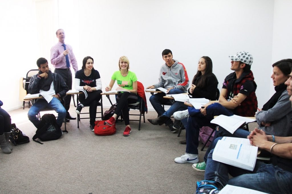 An instructor leads a small-group classroom discussion