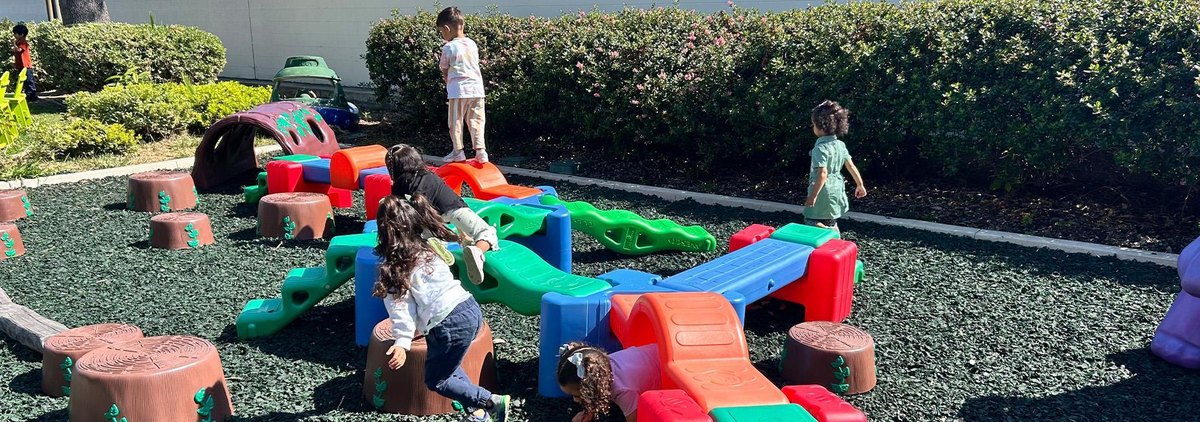 Children explore climbing and play in an outdoor learning area